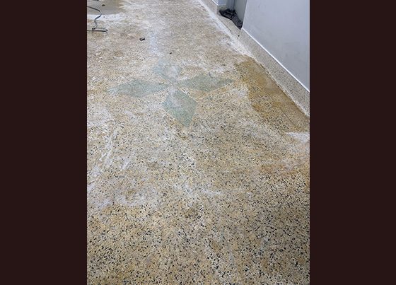 badly damaged terrazzo floor prior to restoration